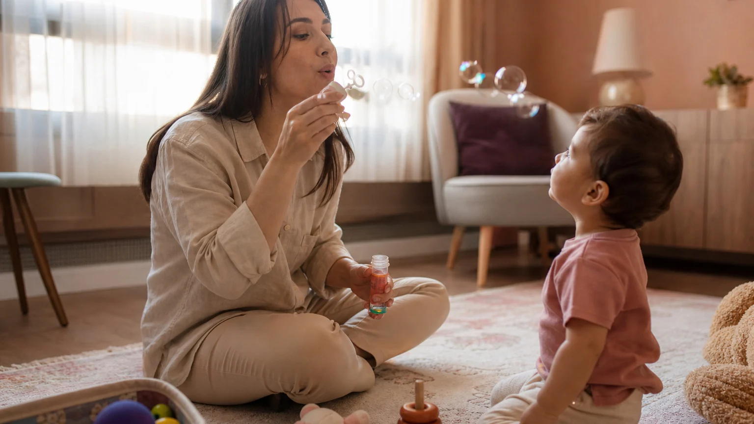 Gelişim değerlendirmesi seansında bir uzman küçük çocukla oyun oynayarak gözlem yapıyor.
